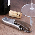 Laguiole Magnum Walnut Corkscrew, close-up of folded stainless steel tool with dark wood handle.