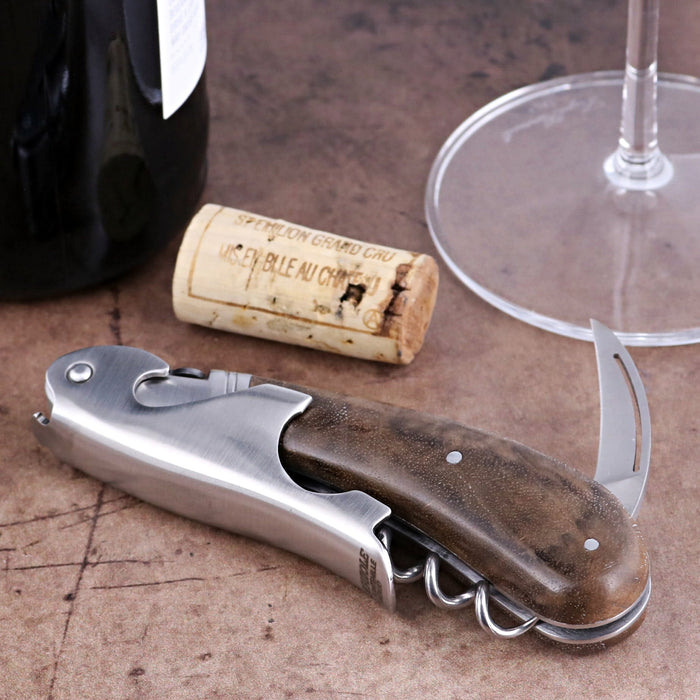 Laguiole Magnum Walnut Corkscrew, close-up of folded stainless steel tool with dark wood handle.