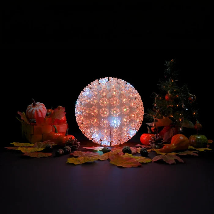 Decorative light ball with pumpkins and leaves on a dark background