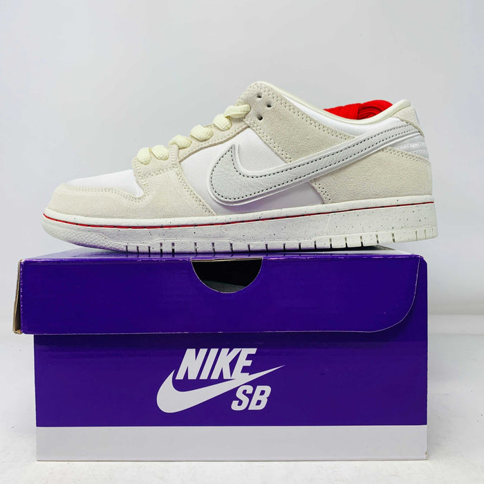 Nike SB Dunk Low City Of Love Light Bone sneakers with red laces, brand new condition, displayed on a purple Nike SB box.