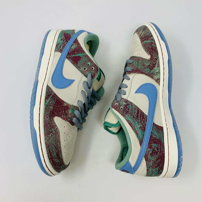 Nike SB Dunk Low Crenshaw Skate Club sneakers with blue Swoosh and red-green pattern.
