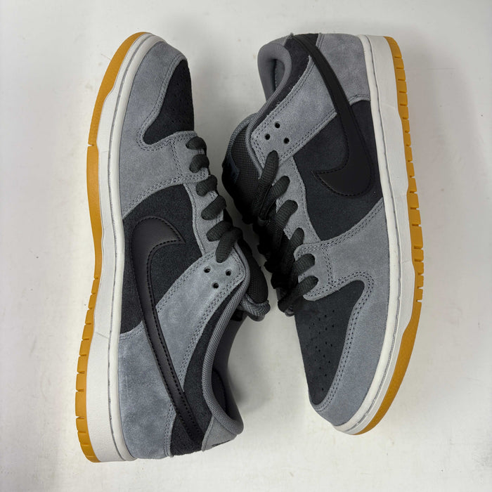 Introducing the Nike SB Dunk Low Dark Smoke Grey sneakers, featuring a gray and black design with a mustard sole. Packaged in a signature purple box with extra black laces, these 100% authentic sneakers ensure your style stays fresh and versatile.
