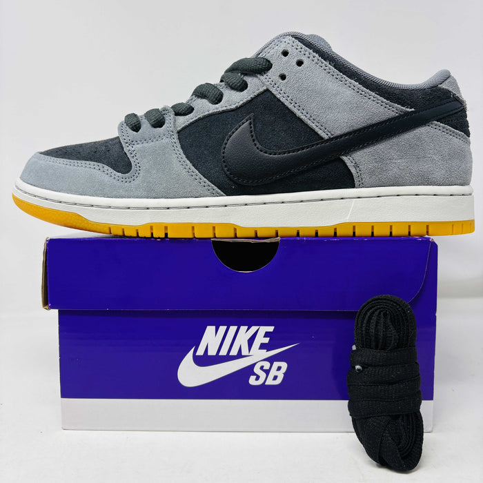 Introducing the Nike SB Dunk Low Dark Smoke Grey sneakers, featuring a gray and black design with a mustard sole. Packaged in a signature purple box with extra black laces, these 100% authentic sneakers ensure your style stays fresh and versatile.