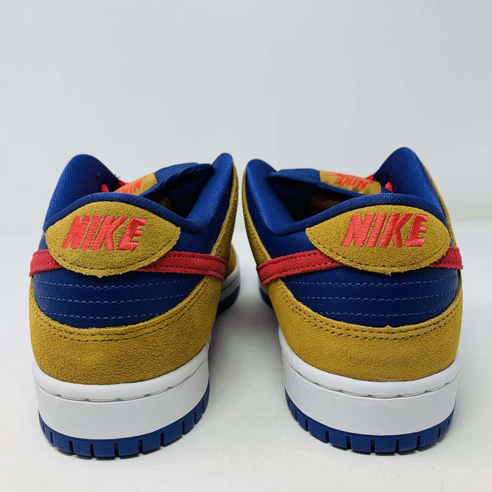The Nike SB Dunk Low Reverse Papa Bear features a blue and yellow suede upper, a red Swoosh, and orange laces. It comes with extra yellow laces in front of its purple Nike SB box and is 100% authentic.
