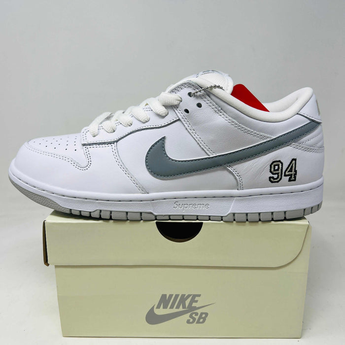 Nike SB Dunk Low Supreme 94 sneaker in white with metallic silver swoosh and number 94 detail on box