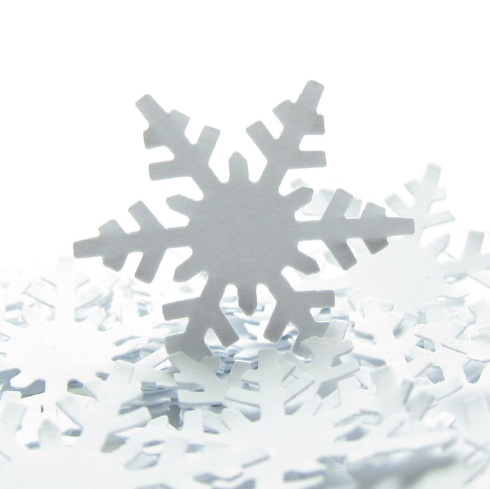 White paper punched alpine snowflakes