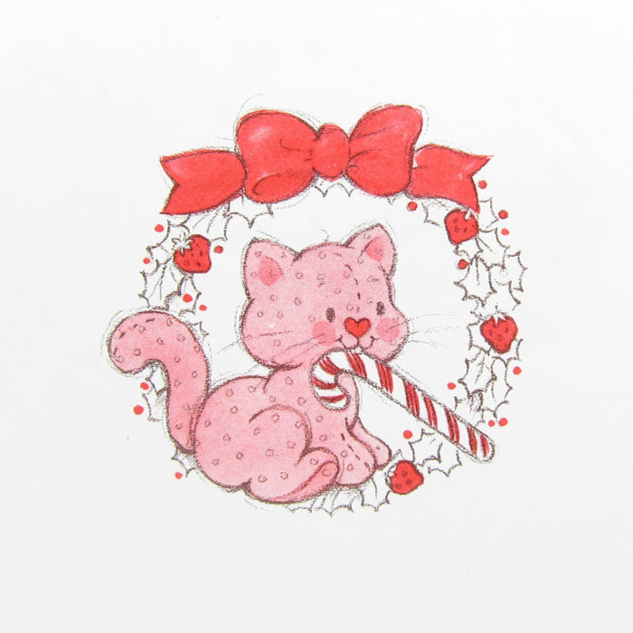 Custard the cat with a candy cane in a wreath