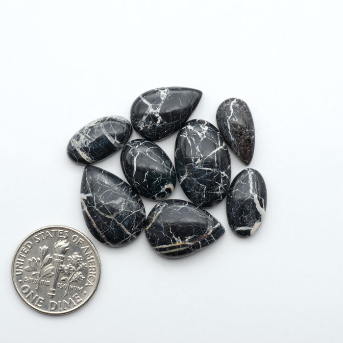 Natural White Buffalo Stone Cabochons are semi-precious gemstones cut into shapes ideal for jewelry-making, making them an excellent choice for artisans.